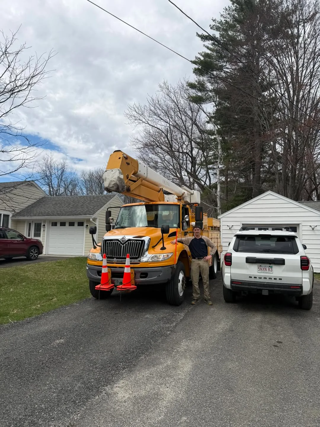 Beaver Tree Experts owner standing next to the company lift truck